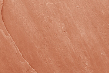 Texture of a stone wall closeup with dirty rough cement pattern and vintage aged brown surface