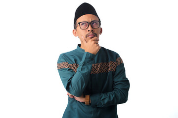 Confused Asian Muslim man, with a pensive hand on his chin, looking up thoughtfully, isolated on a white background