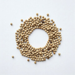 Obraz premium White pepper seeds in circle on white background. Top view. Flat lay.