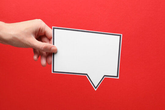 Woman holding blank speech bubble on red background, closeup. Space for text