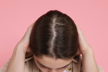 Girl with hair loss problem on pink background