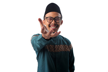 Asian Muslim man extending his hand toward the camera with a welcoming smile, making an inviting 