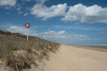 Genuine, 30 kilometres per hour speed limit sign on Riper Beach on the West Coast of the North Island of New Zealand. Riper Beach is New Zealand's longest drivable beach at 107 kilometres.