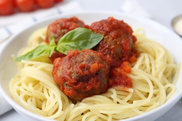 Delicious pasta with meatballs in bowl on table, closeup