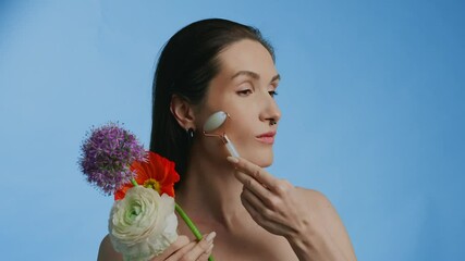 Skincare routine with floral accents featuring a beauty roller