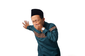 Asian Muslim man feeling queasy with his hand covering his mouth, possibly due to food poisoning...