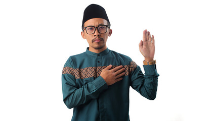 Asian Muslim man places his hand on his chest, making a sincere gesture of an oath or promise,...
