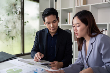 Financial Insights and Teamwork. Colleagues collaborating on financial reports in a bright office.