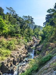 Rocky river, tropical forest, green hills, water stream, nature tourism, natural beauty, ecosystem, environment, serenity, exploration.
