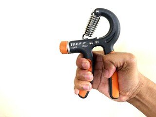 A person is holding a hand grip for exercise.