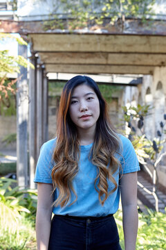 Young Asian woman enjoying time outdoors at enclave
