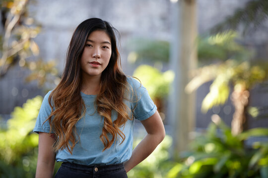 Young Asian woman enjoying time outdoors at enclave