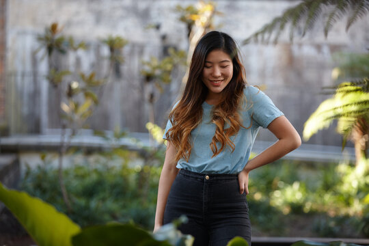Young Asian woman enjoying time outdoors at enclave