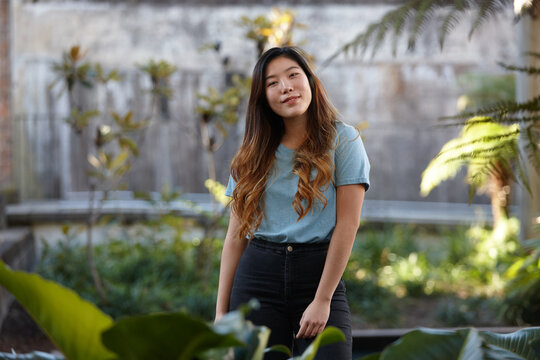 Young Asian woman enjoying time outdoors at enclave