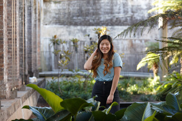 Young Asian woman enjoying time outdoors at enclave