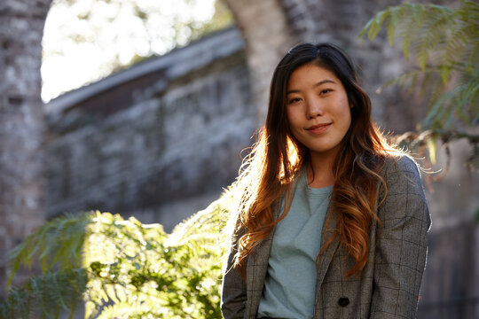 Young Asian woman enjoying time outdoors at enclave