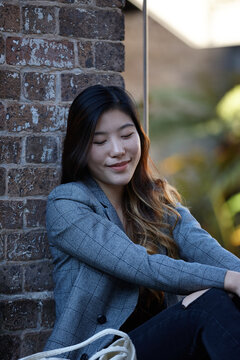 Young Asian woman enjoying time outdoors at enclave