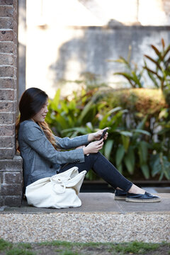 Young Asian woman enjoying time outdoors at enclave
