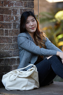 Young Asian woman enjoying time outdoors at enclave
