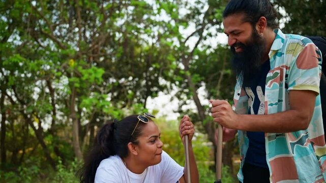 Bearded Backpacker Laughs with Companion on Scenic Trail