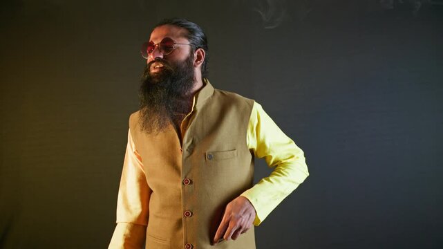 Bearded man in vest relishes his smoke