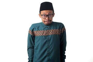 Shy Asian Muslim man looking embarrassed, biting his lower lip and wanting to say something while...