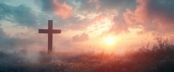 Fototapeta premium Jesus Christ Cross in Misty Meadow Sunrise with Ethereal Clouds and Soft Pastel Colors for Good Friday and Easter