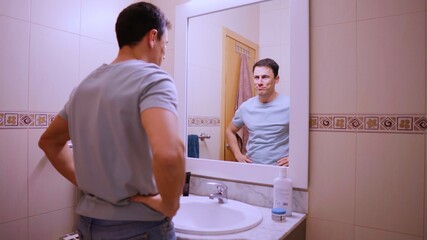 Confident man looking at himself, starting the day with optimism