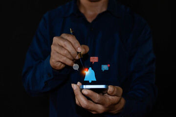 Concept of push notification alert, web notification, schedule and announcement. A man is using a smartphone with notification icons on a virtual screen.
