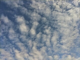 Soft white clouds drifting across a blue sky