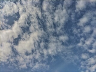 Soft white clouds drifting across a blue sky