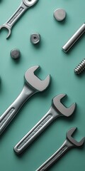 Assorted tools and bolts laid out neatly on a teal surface, creating a sense of order and precision.