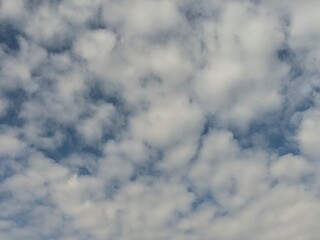 Soft white clouds drifting across a blue sky