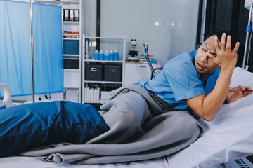 Lonely man silhouette sitting on the bed feeling depressed and stressed in the dark bedroom, Depression and anxiety disorder concept