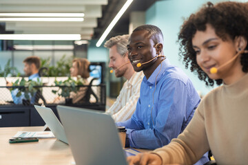 Fototapeta premium Attractive positive young businesspeople and colleagues in a call center office.