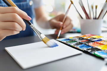 Woman applying the final brushstroke on a digital tablet to create a beautiful artistic masterpiece