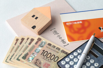 遺言状と残されたマイホームや通帳や札束と電卓と印鑑