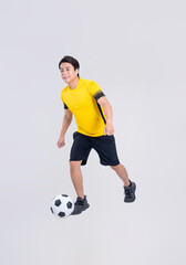 Portrait of Asian man playing soccer on white background