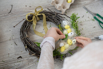 DIY process of woman making candid Easter wreath arrangement decor. Small business, self employed...