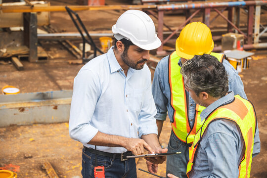 Construction engineer team working together join teamwork talking together at construction site