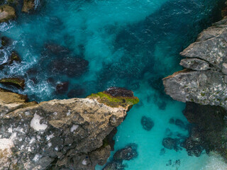 Southwest Sumba, East Nusa Tenggara, Indonesia –  07. 14. 2024 – From above, the dramatic inlet through which Mandorak’s fishing boats pass between giant karst rocks to reach the open waters of South 