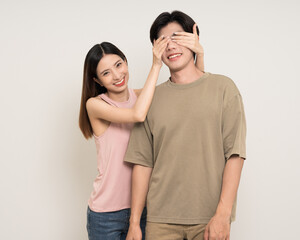Close the. eyes guess what Happy asian couple attractive in various action gesture standing on isolated white background. Cheerful Smiling young man and woman hide and seek
