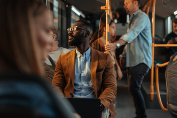 Black man enjoying the sun rays on his face on the bus