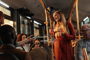 Pregnant woman being offered a seat on the bus
