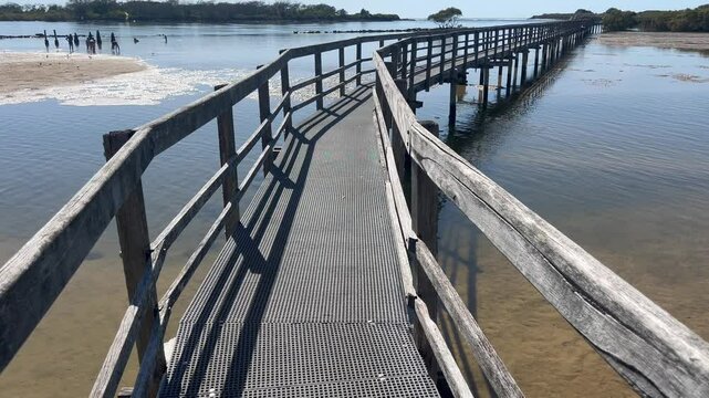 Aerial drone landscape view of Urunga Wetlands wooden boardwalk in New South Wales Australia.