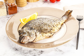 Baked Dorado fish served lemon