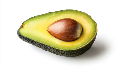 A halved avocado with a large seed inside, sitting on a white surface under bright studio lighting