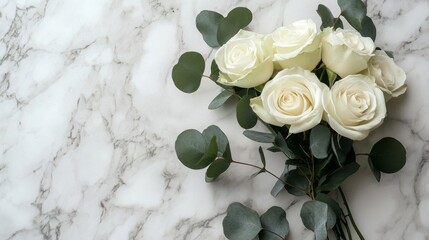 White Roses and Eucalyptus on Marble Background