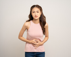 A woman had a stomach ache and gastritis. She put her hand on her stomach and squeezed it to relax and soothe. Unwell unhealthy female menstrual cramps on isolated white background.