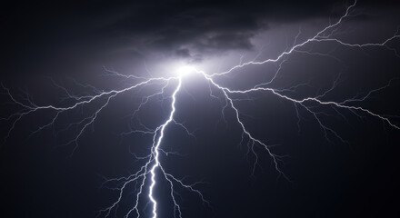 A powerful strike of lightning illuminates the night sky during a severe thunderstorm.